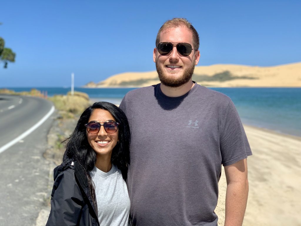 a photo of me and my husband on the beach in new zealand