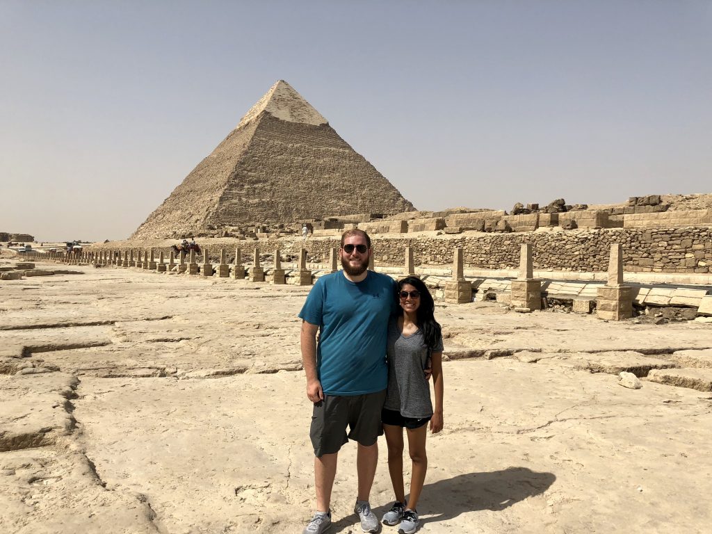 a picture of me and my husband in front of the pyramids in egypt