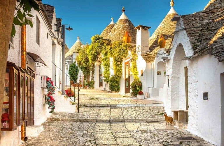 White tent like buildings with a brown roof showing what is Italy known for.