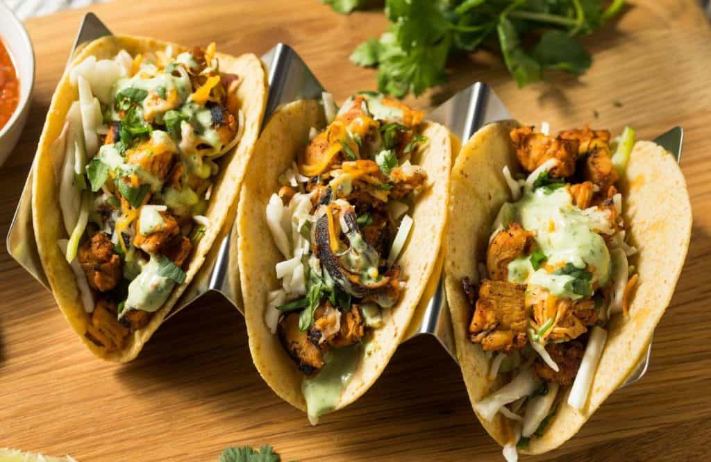 Three street tacos on a plate.