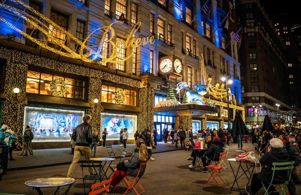 Macy's on Herald Square at night adorned in Christmas lights.