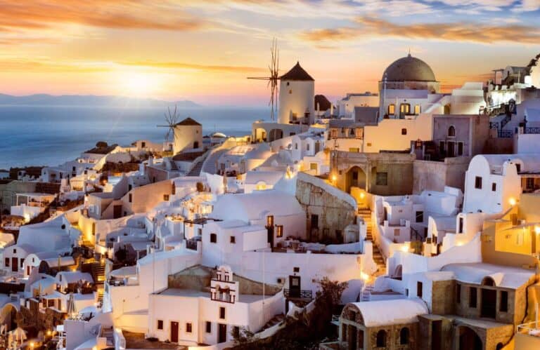 White-washed buildings at sunset on one of the best Greek islands for couples.