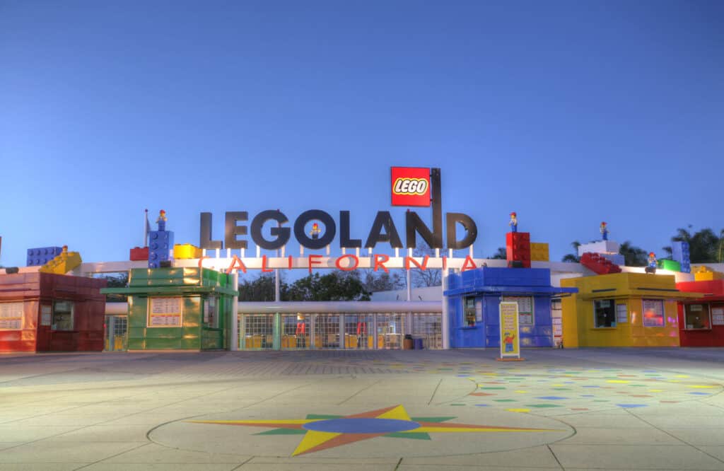 LEGOLAND California theme park entrance with blue, yellow, and green Lego looking buildings.