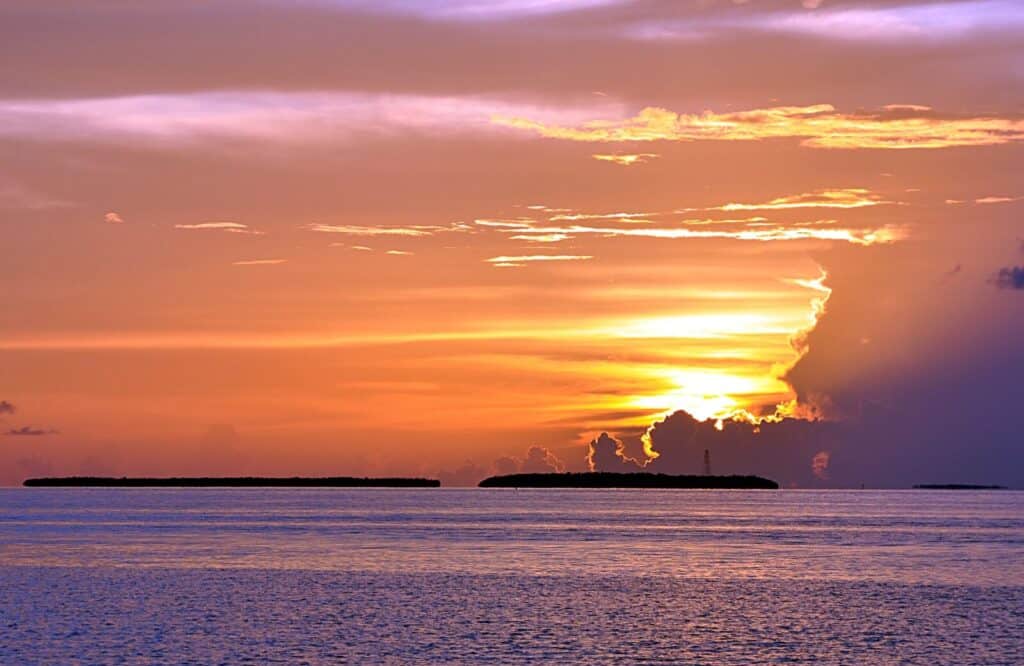 A sunset over the ocean in Key West with bright orange and yellow skies.