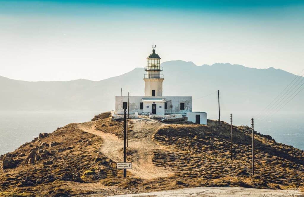 Armenistis Lighthouse perched on a hill in Mykonos.